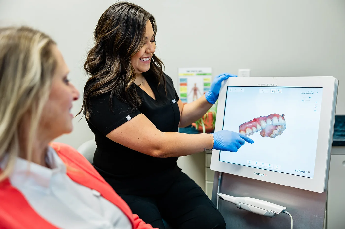 Patient reviewing a digital Invisalign-style treatment scan on a chairside screen