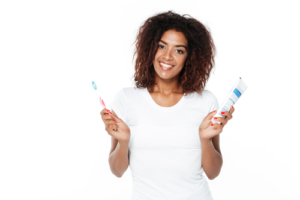 woman holds toothpaste